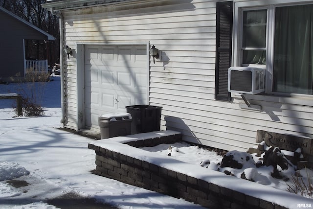 view of snowy exterior with a garage