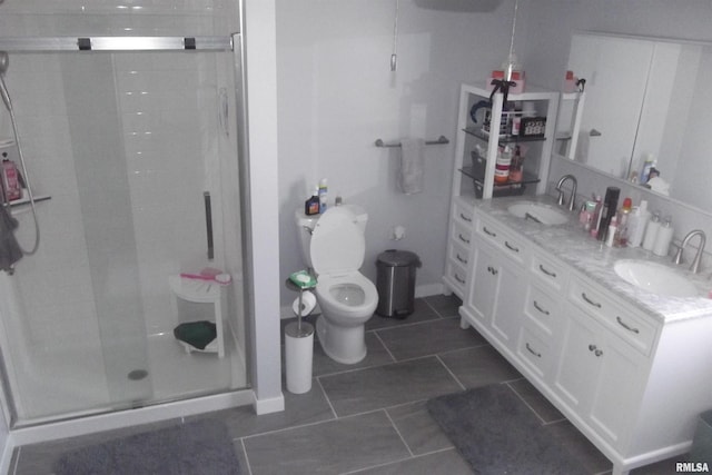 bathroom featuring vanity, toilet, tile patterned floors, and a shower with shower door