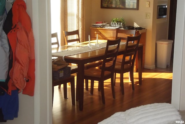 dining space with wood finished floors