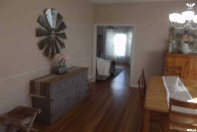 dining area featuring an inviting chandelier and wood finished floors