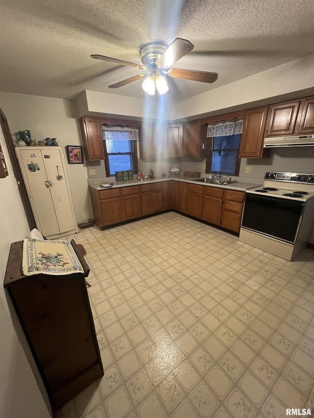 kitchen with ceiling fan, white range with electric cooktop, sink, and a textured ceiling