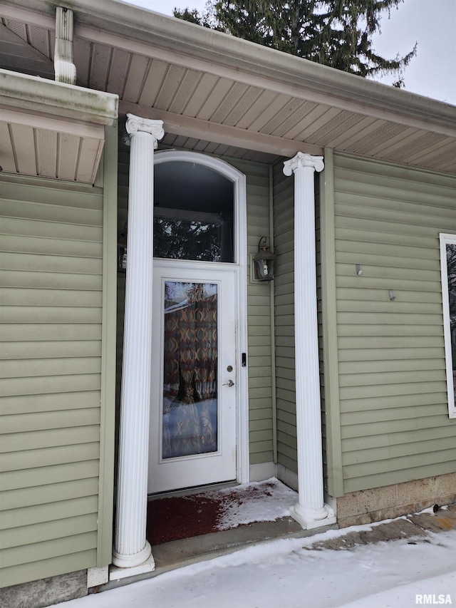 view of snow covered property entrance