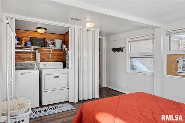 bedroom featuring washer and dryer and dark wood-type flooring