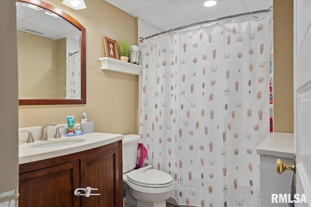 bathroom featuring walk in shower, vanity, and toilet