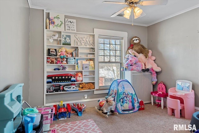 game room featuring ceiling fan, ornamental molding, and carpet