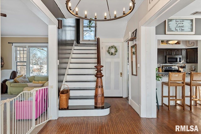 foyer featuring crown molding and dark wood-type flooring