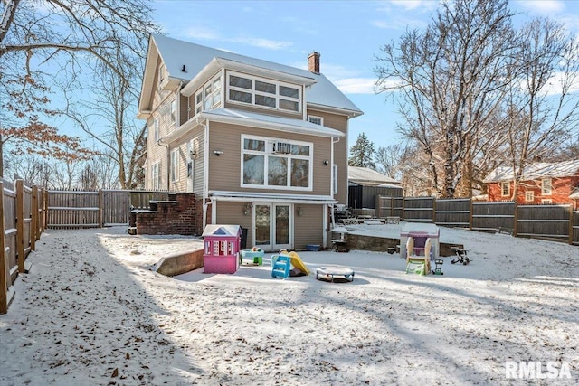 snow covered property with an outdoor fire pit