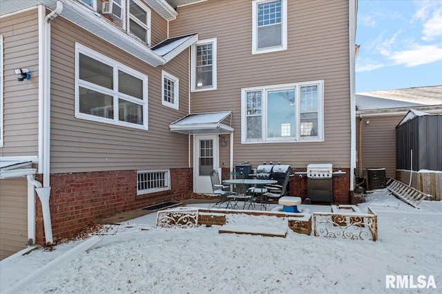 view of snow covered back of property