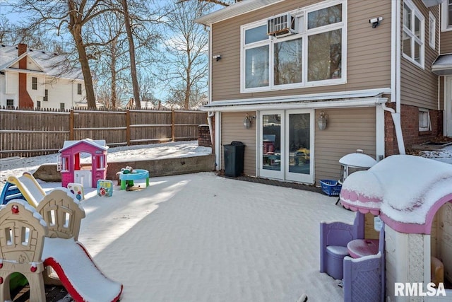 snow covered patio with a playground