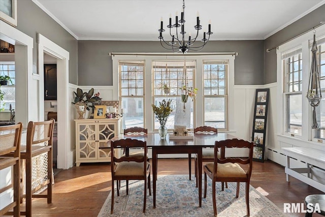 dining space featuring a notable chandelier, crown molding, and dark hardwood / wood-style floors