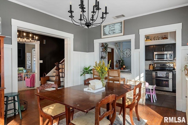 dining area featuring an inviting chandelier, dark hardwood / wood-style flooring, and crown molding