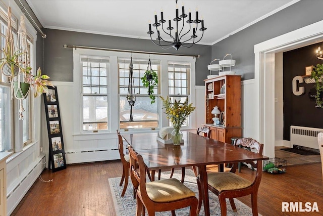 dining space with ornamental molding, radiator heating unit, dark hardwood / wood-style floors, and a baseboard heating unit