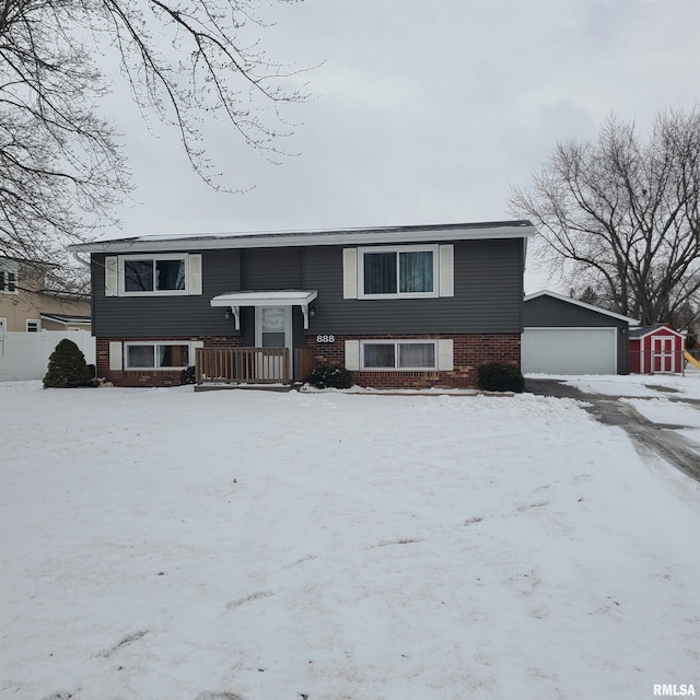 bi-level home with a garage and an outbuilding