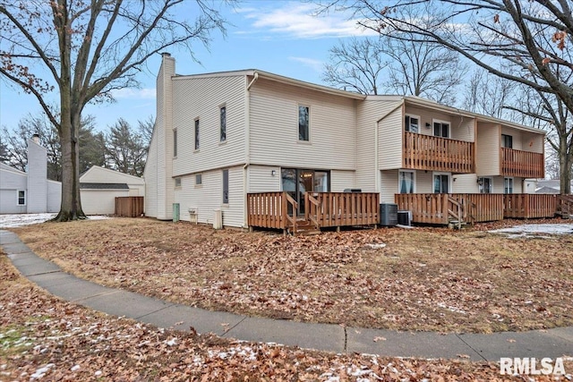 exterior space with a wooden deck, central AC, and a balcony