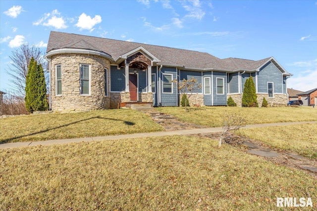 view of front of home with stone siding and a front yard