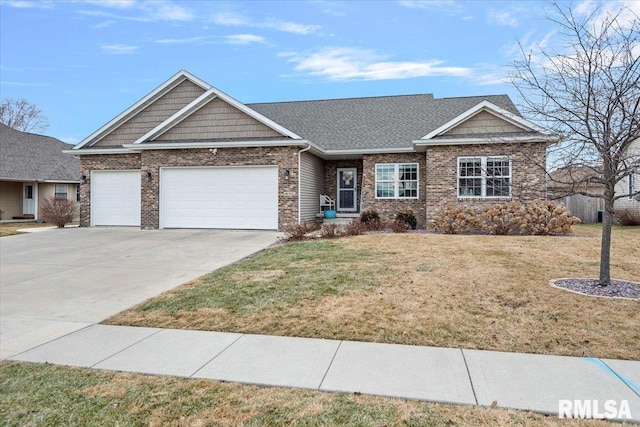 view of front of property featuring a front lawn and a garage