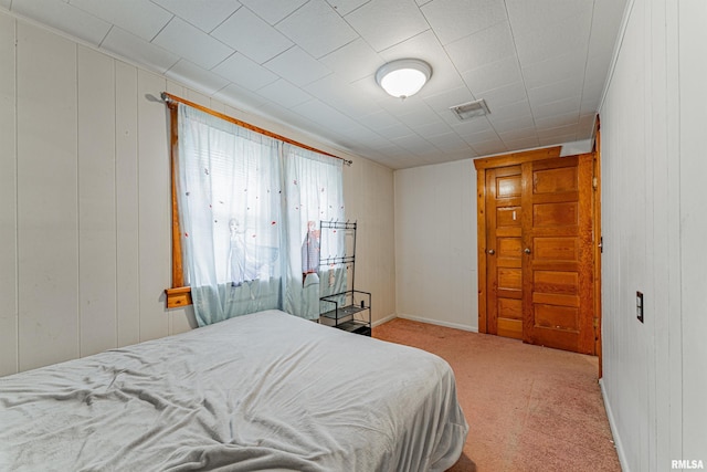 bedroom featuring light carpet