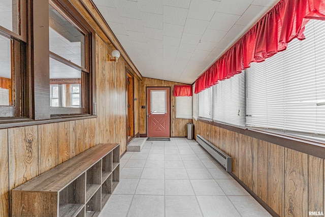 unfurnished sunroom featuring lofted ceiling and baseboard heating