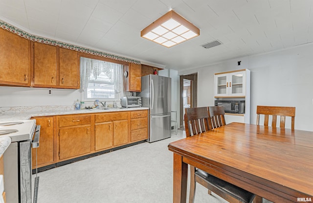 kitchen with stainless steel refrigerator, sink, and stove