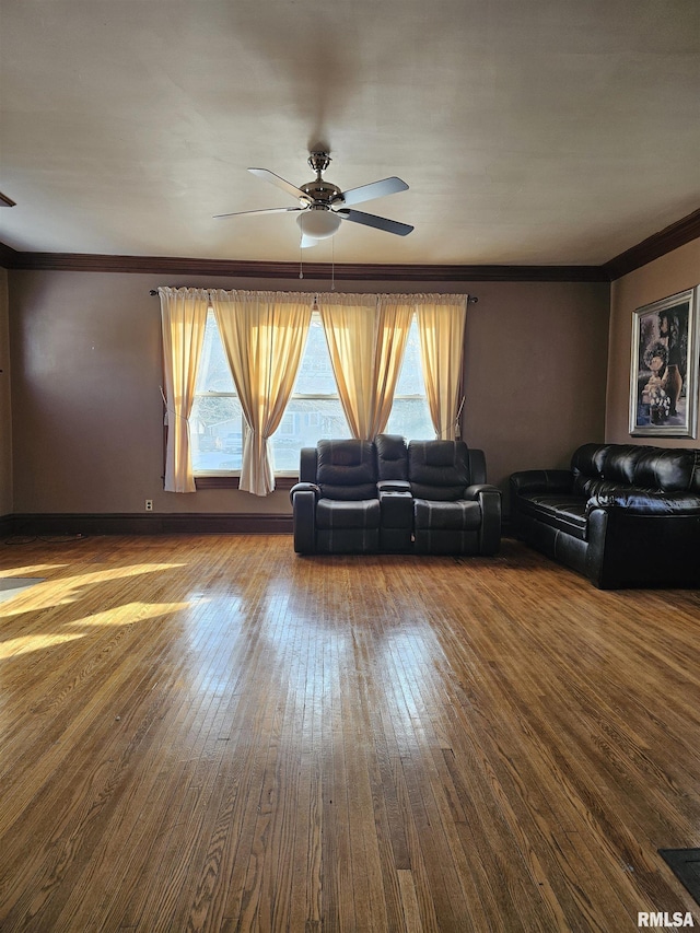 unfurnished living room with hardwood / wood-style flooring, ceiling fan, and crown molding