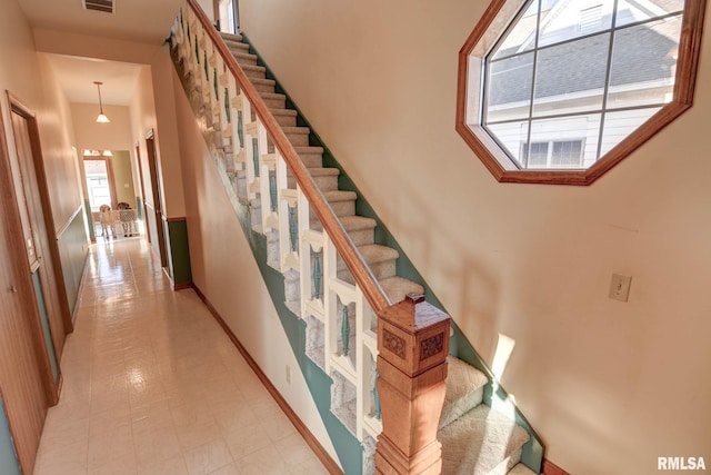 staircase featuring visible vents and baseboards