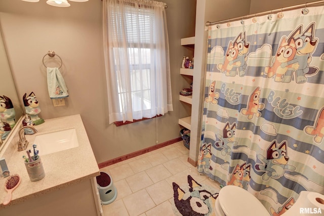 bathroom featuring baseboards, toilet, a shower with curtain, tile patterned flooring, and vanity