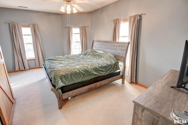 bedroom with light carpet, multiple windows, and visible vents