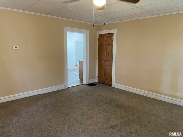 carpeted spare room with baseboards and crown molding