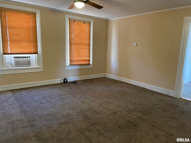 spare room with cooling unit, carpet, crown molding, baseboards, and ceiling fan