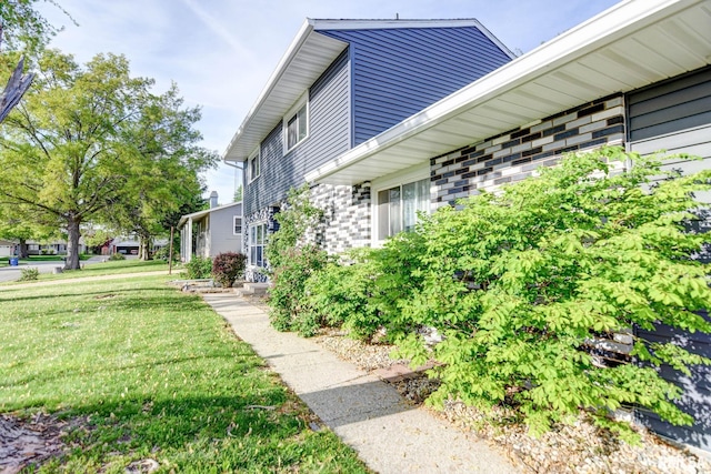 view of home's exterior with a yard