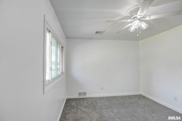 empty room featuring carpet flooring, baseboards, visible vents, and ceiling fan