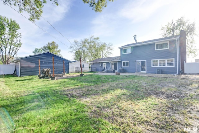 rear view of property with a lawn, fence, a patio, and a chimney
