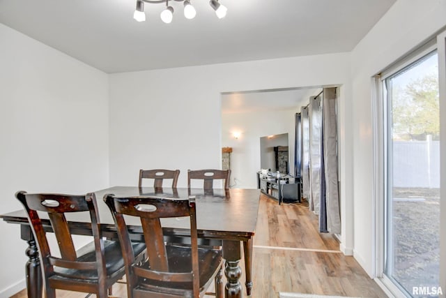 dining room with wood finished floors and a chandelier