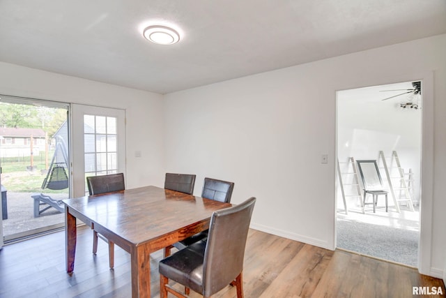 dining area with baseboards and wood finished floors