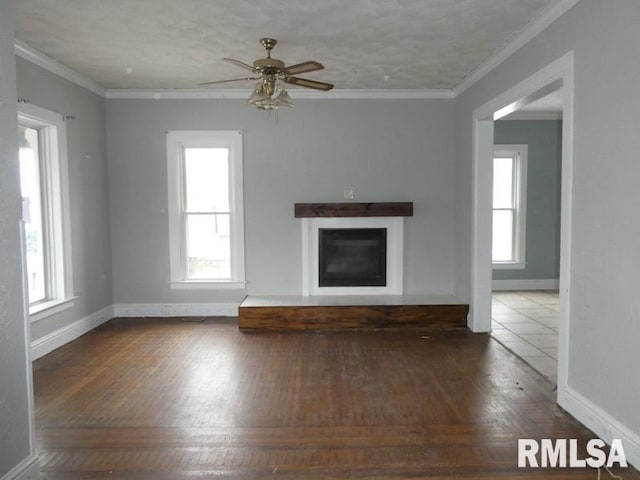 unfurnished living room with ceiling fan, crown molding, and dark hardwood / wood-style flooring