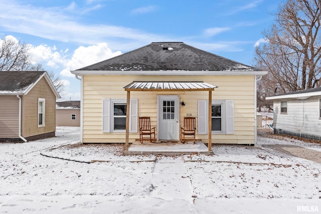 view of snow covered rear of property