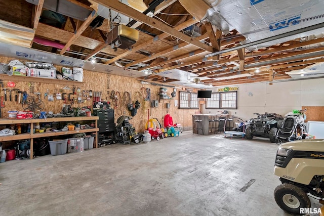 garage with a garage door opener and a workshop area