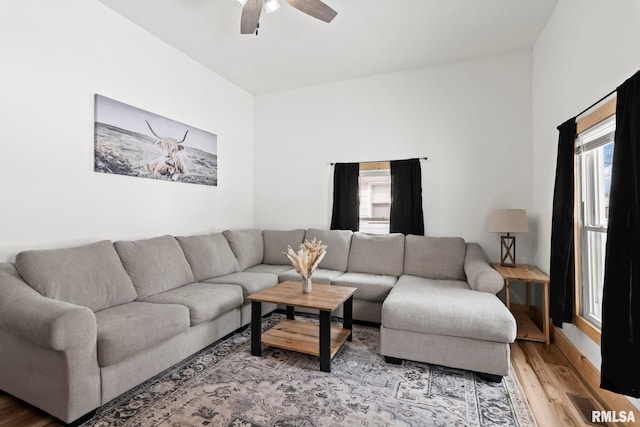 living room with hardwood / wood-style flooring and ceiling fan