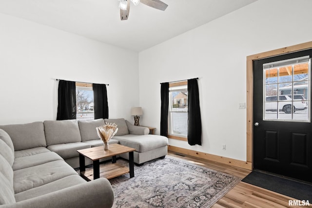 living room featuring ceiling fan and hardwood / wood-style floors