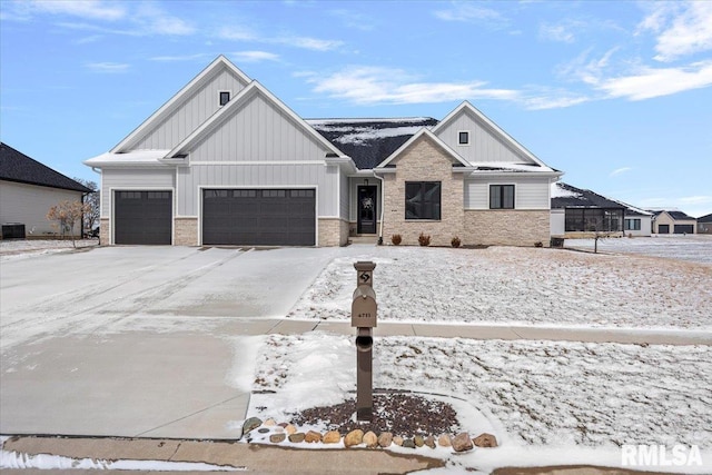 view of front of property featuring central AC unit and a garage