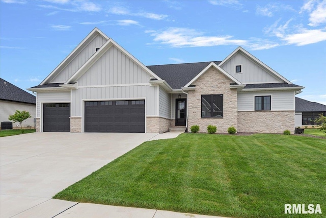 view of front of property featuring board and batten siding, a front yard, concrete driveway, an attached garage, and stone siding