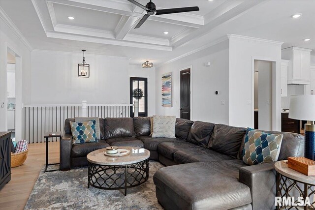 living room with crown molding, beamed ceiling, coffered ceiling, a ceiling fan, and light wood finished floors
