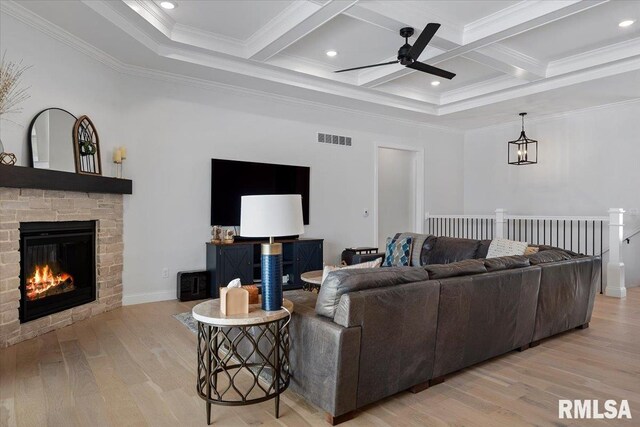 living area featuring a ceiling fan, visible vents, crown molding, beam ceiling, and light wood-style floors