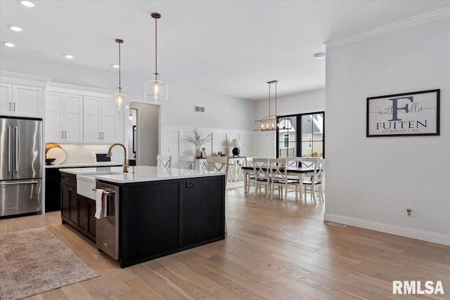 kitchen featuring visible vents, recessed lighting, light countertops, a sink, and appliances with stainless steel finishes