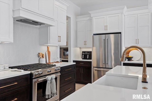 kitchen featuring light countertops, white cabinetry, appliances with stainless steel finishes, and tasteful backsplash