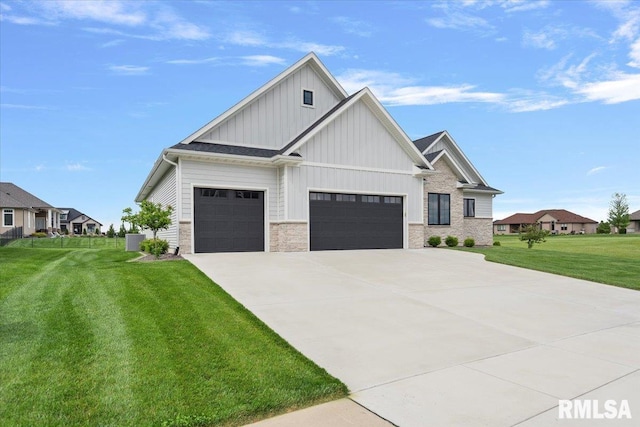 view of front of property featuring a garage, a front lawn, stone siding, board and batten siding, and driveway