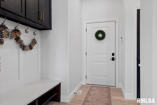 mudroom with baseboards and light wood-style flooring