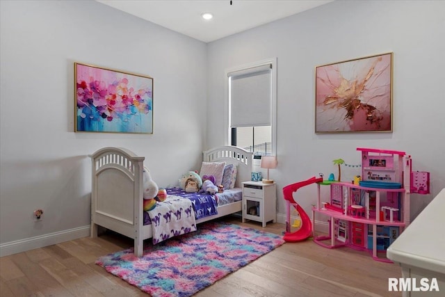 bedroom with baseboards, recessed lighting, and wood finished floors