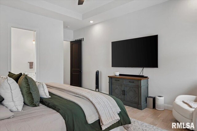 bedroom with ensuite bath, visible vents, baseboards, light wood-style floors, and recessed lighting
