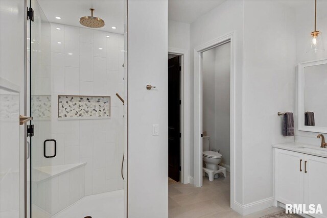 bathroom featuring a shower stall, vanity, baseboards, toilet, and recessed lighting